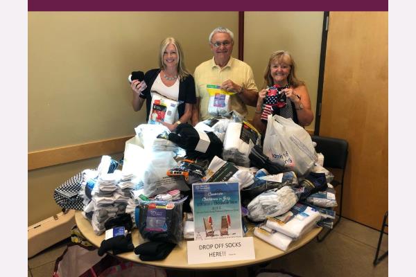 Home Instead Joins Battle Ground Senior Citizens for a Christmas in July Sock Drive