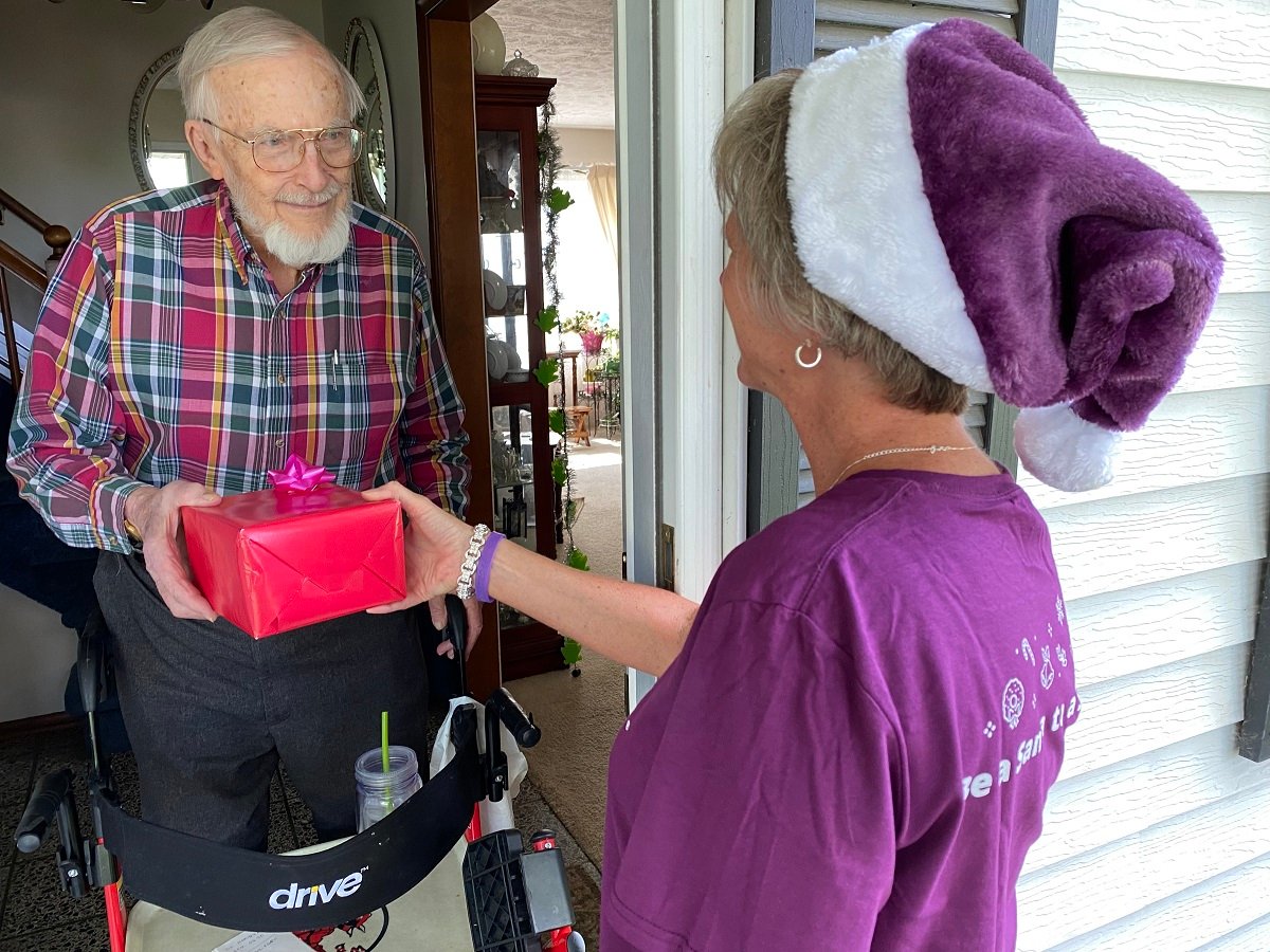 Caregiver delivering gift to senior