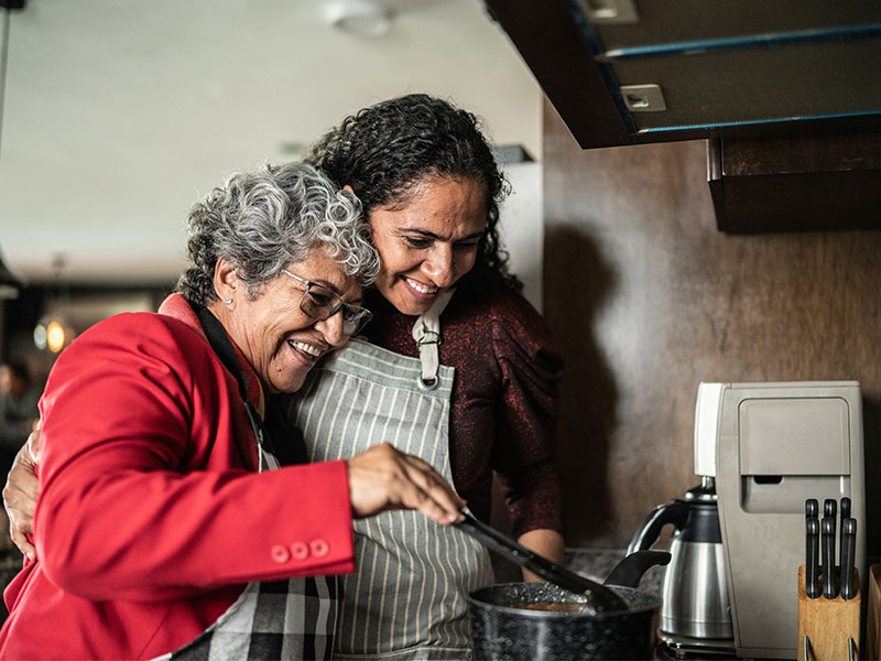 respite care 800x600px happy caregiver and senior lady cooking