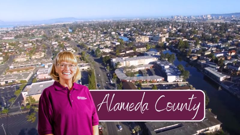 Home Instead caregiver with Alameda County, CA in the background