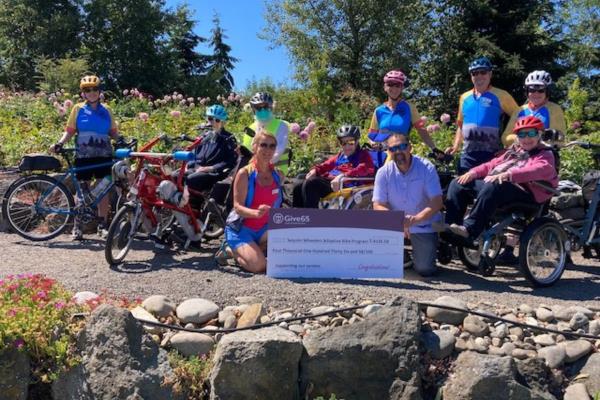 Give65 Check Presentation to Sequim Wheelers 2022 hero