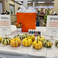 table with pumpkins and supplies for the painting contest