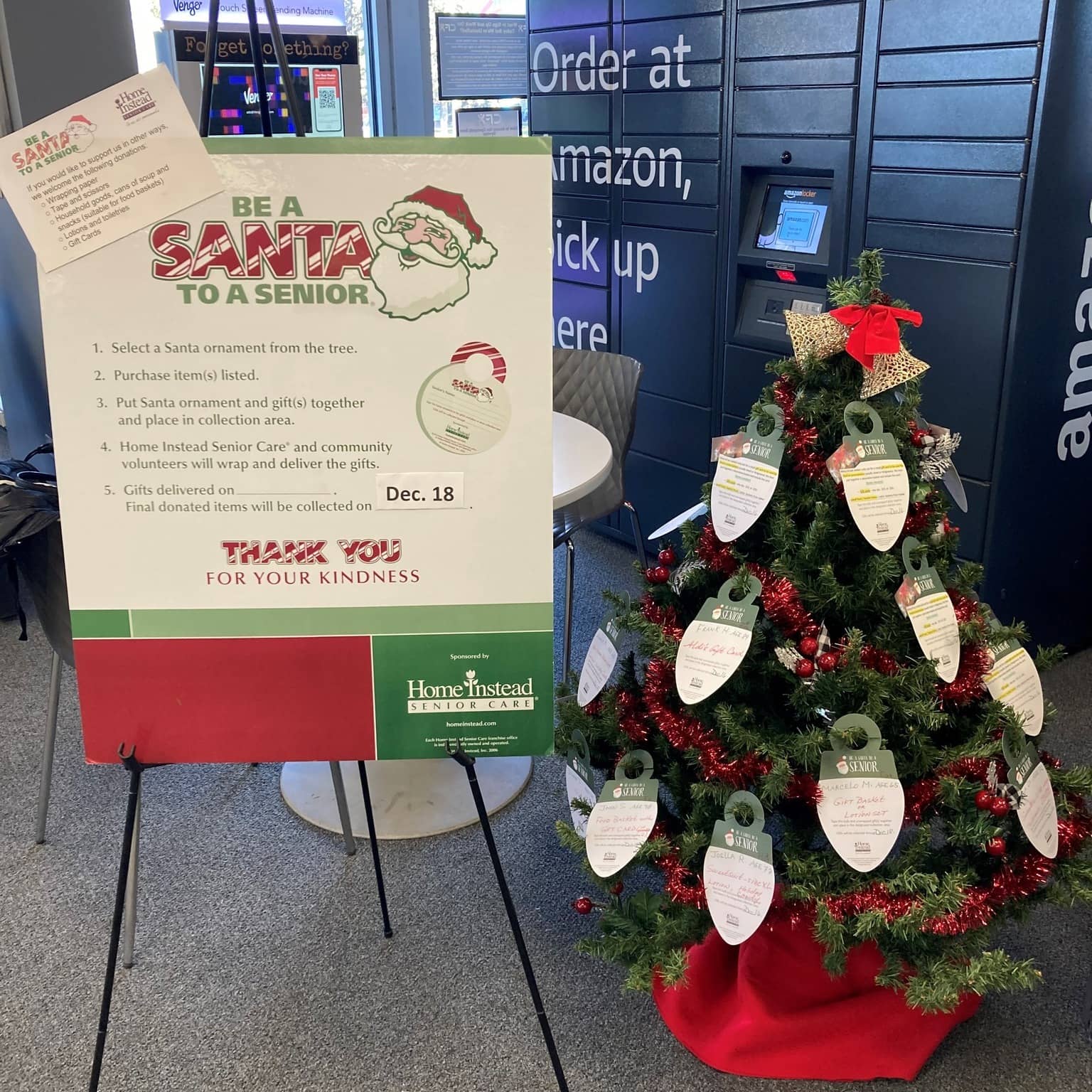 Photo of BASTAS tree in front of an Amazon pick up station with information sign to the left