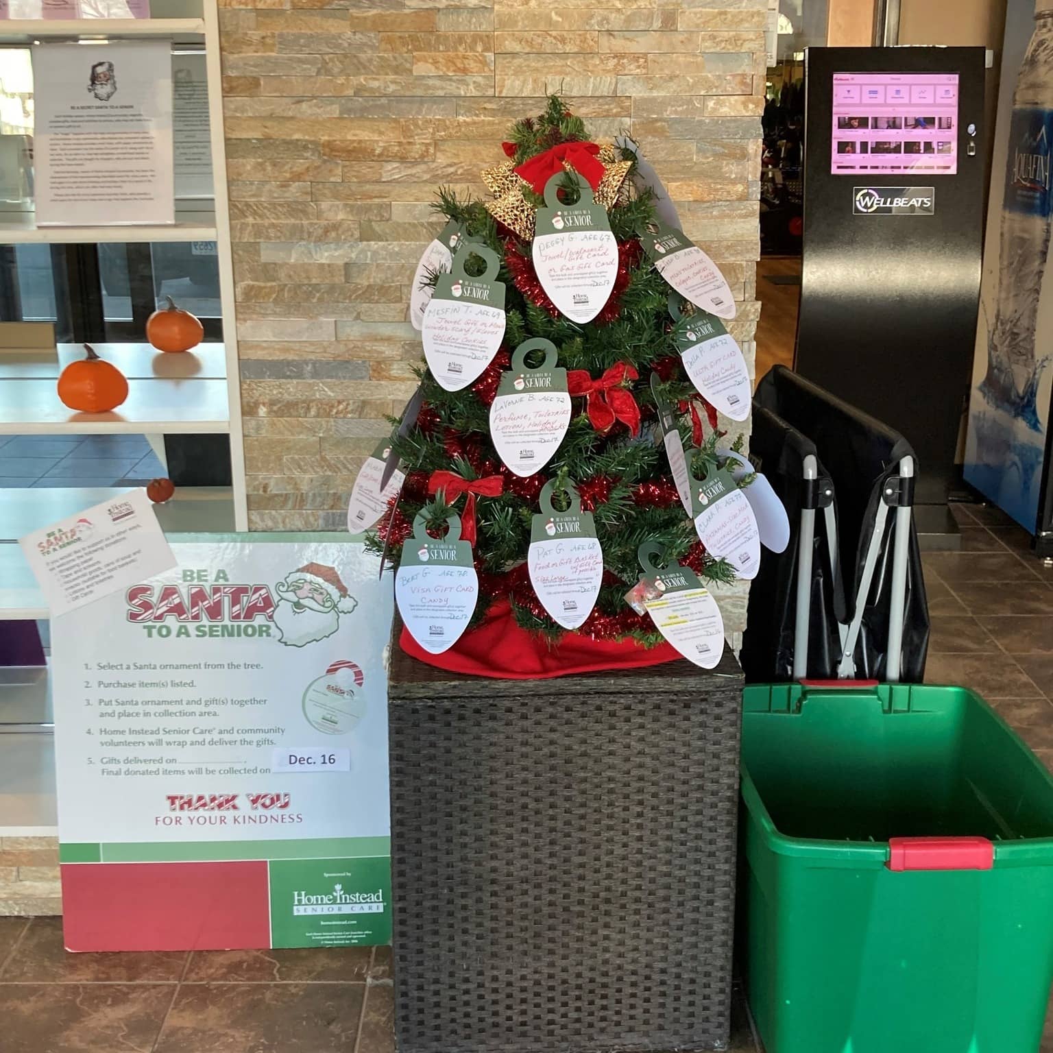 Photo of BASTAS tree with information sign on the left and donation bin on the right