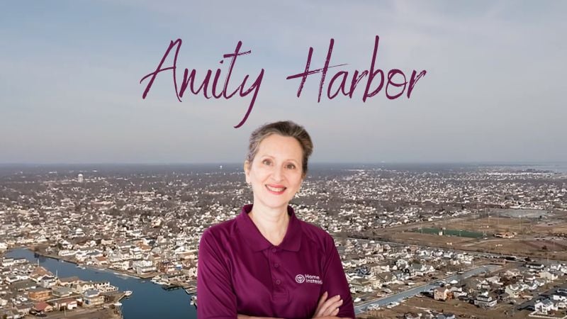 Home Instead caregiver with AMity Harbor New York in the background