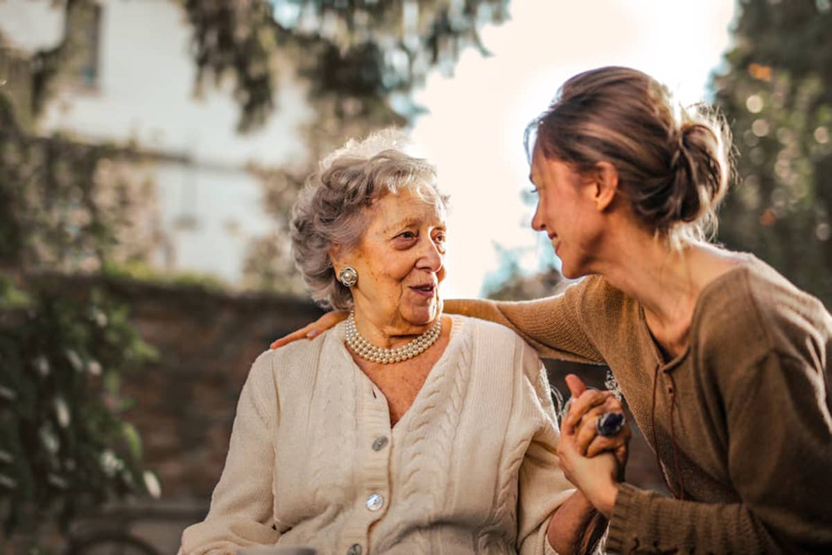 Family Caregiver embracing a Senior out in the Garden 1 