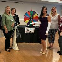 event participants standing by a gameshow wheel