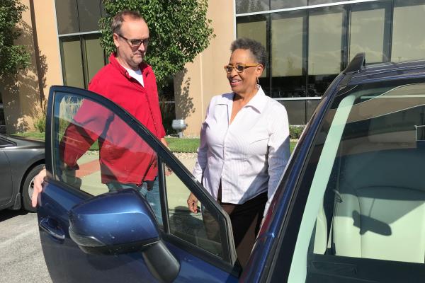 man opens car door for woman