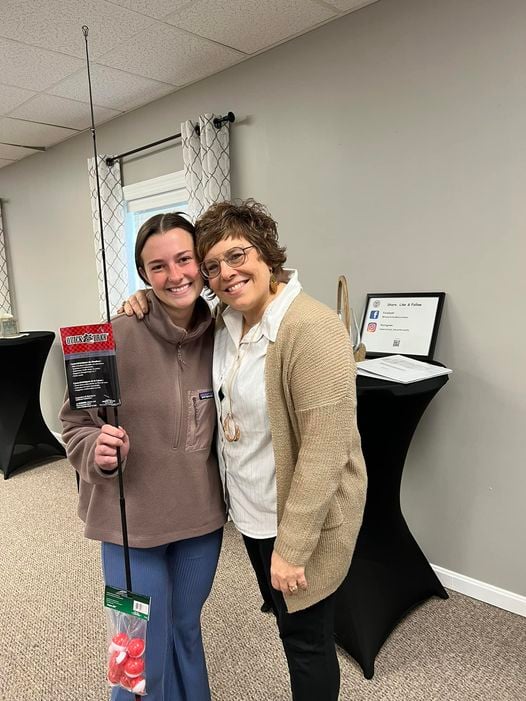 Home Instead caregiver, Claire, standing with her new fishing rod.