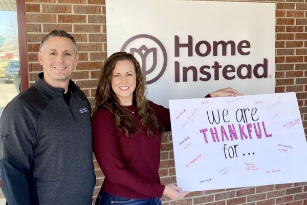 owners of home instead of seward nebraska holding caregiver appreciation sign