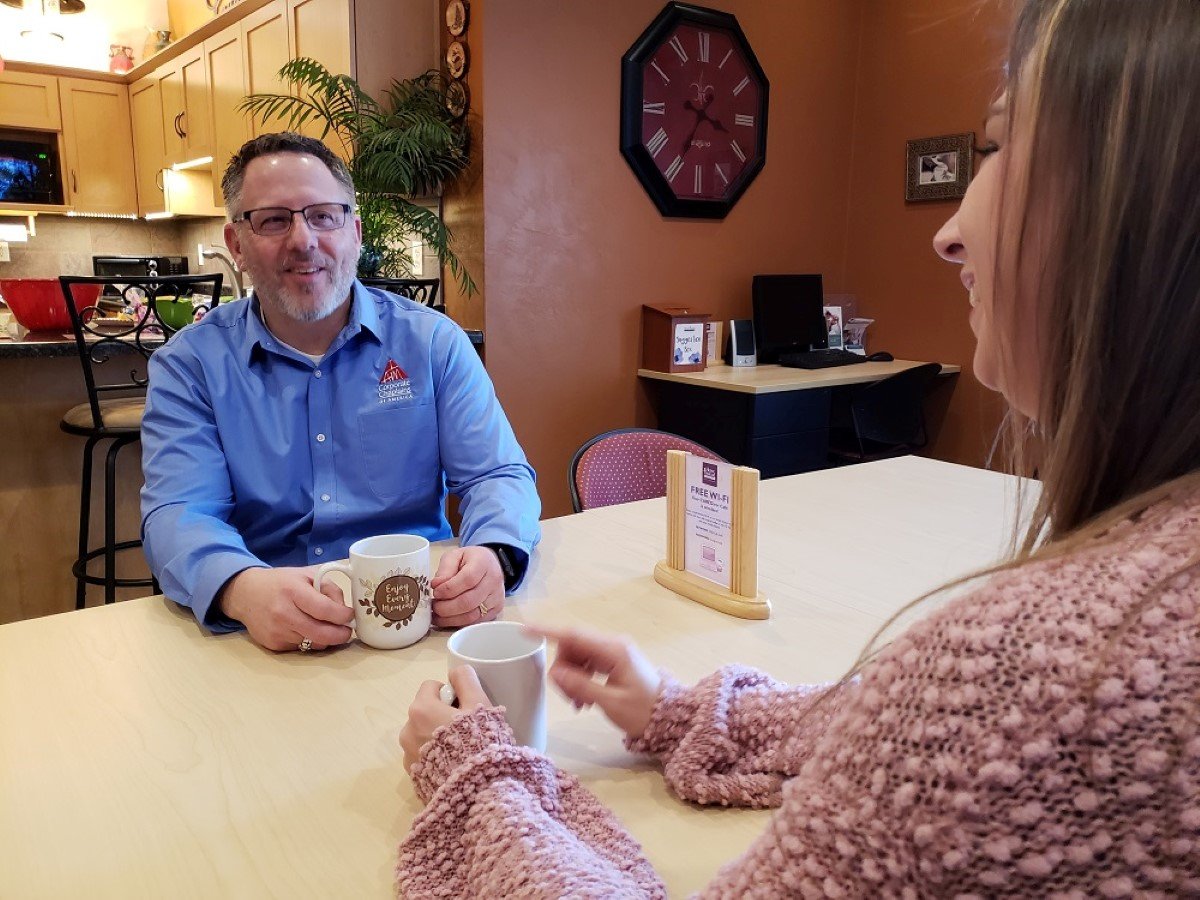 man and woman in a cafe drinking coffee