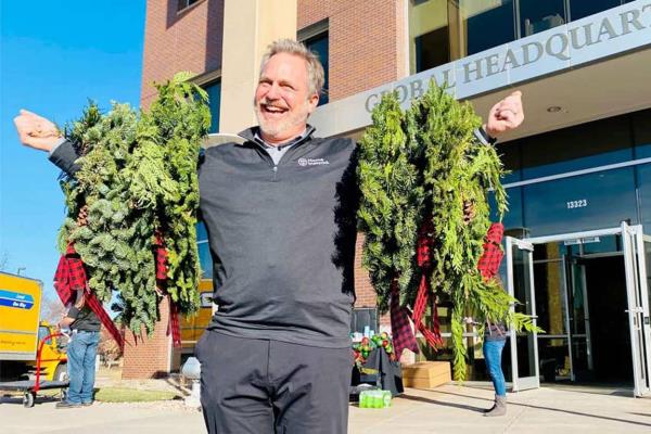 smiling man delivering wreaths to seniors