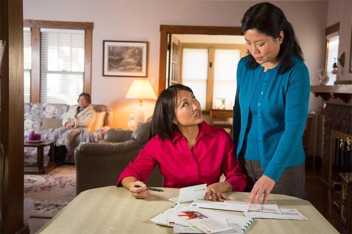 two adult children reviewing their mother's long term care insurance policy