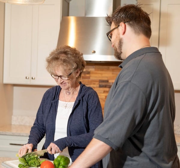 Caregiver helping senior make a meal