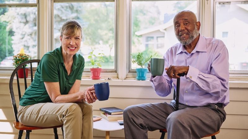 Home Instead caregiver and senior client sharing a cup of coffee