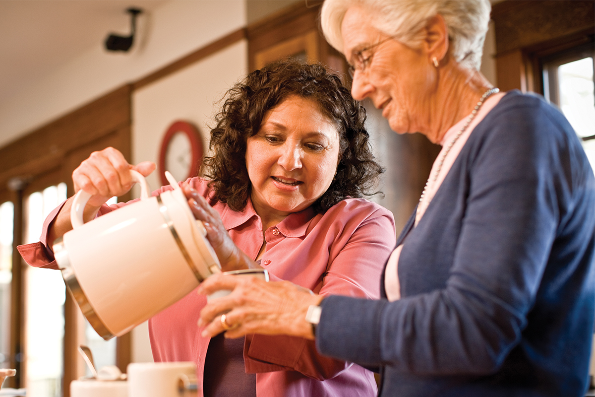 Caregiver pouring a drink