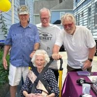 Miss Celia posing with her friends/community celebrating her 100th birthday