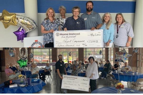 Photo of owner handing large check to non-profit organizer