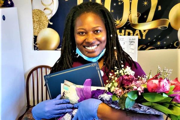 Shelia Graves, holding balloons and flowers is our Care Professional of the 2nd Quarter of 2022.