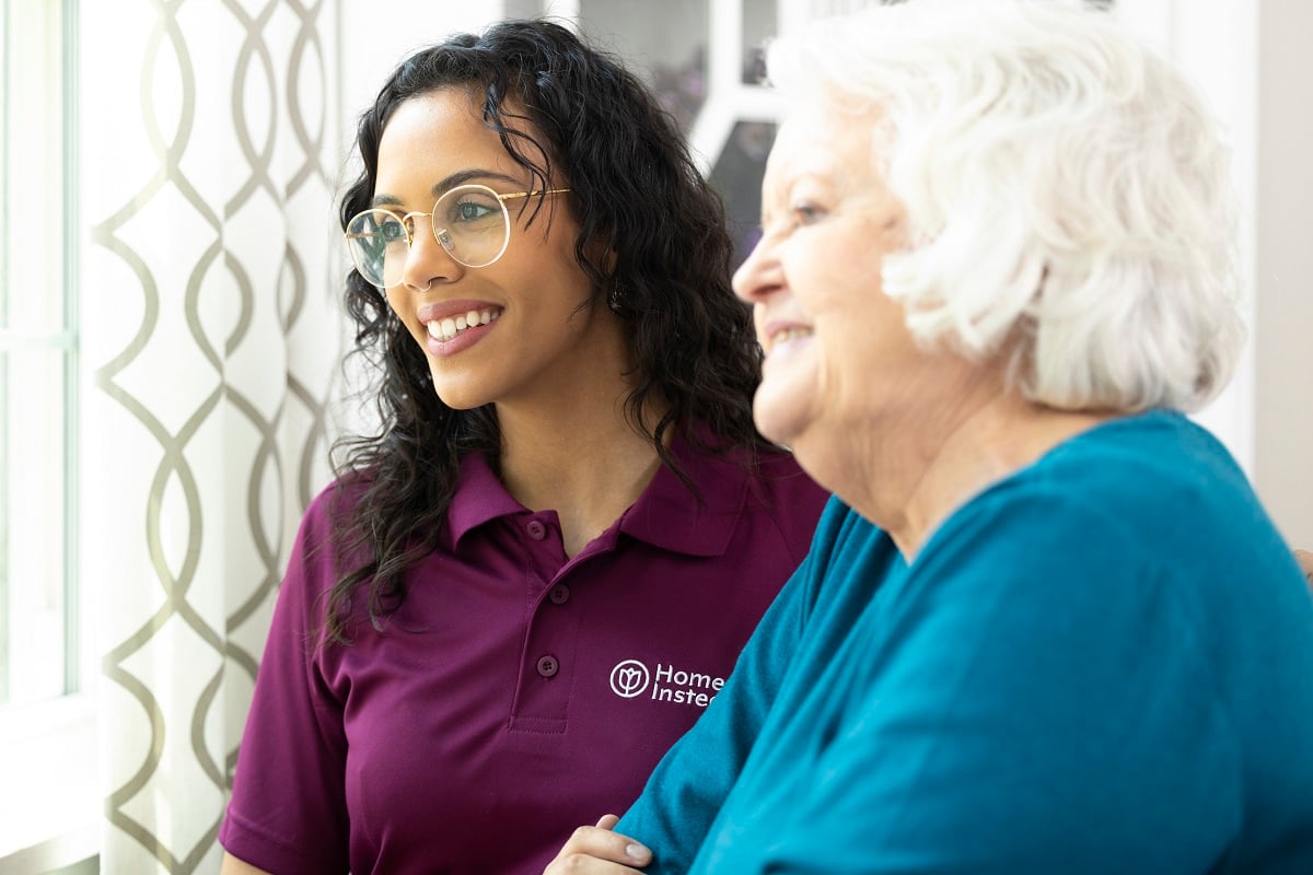 Home Instead and Honor Care Professional and aging woman smiling