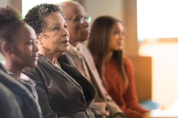 family sits together in church pew