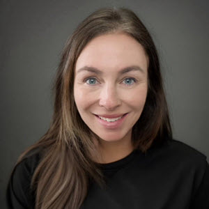 Kim Atkinson, Chief Communications Officer of Home Instead, smiling in a professional headshot, symbolizing trust and effective communication.