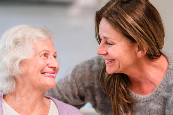 senior woman reads magazine caregiver