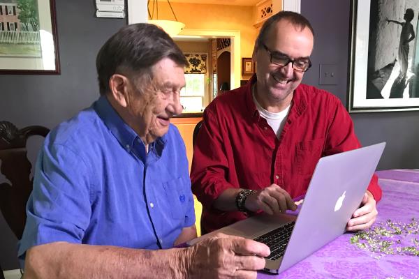 Father and son looking at computer.