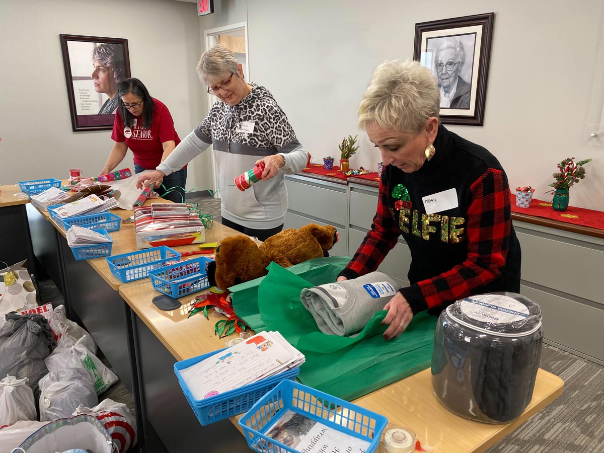 home instead giving back by donating gifts during the holiday season