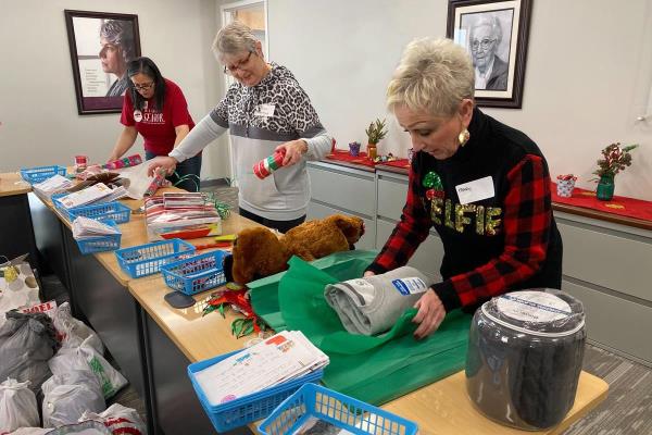 home instead giving back by donating gifts during the holiday season