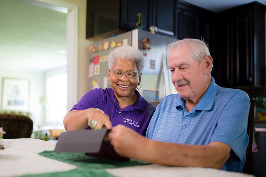 Home-Instead-caregiver-with-aging-adult-looking-at-tablet.jpg