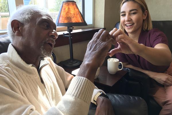 Older man and caregiver smiling