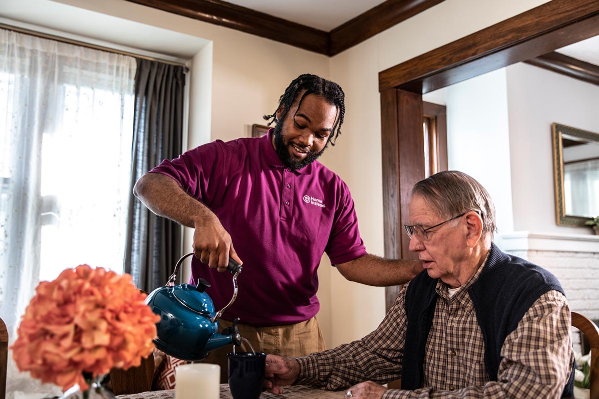 CAREGiver pouring a cup of coffee for a client during Overnight Care.